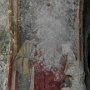 ... sul pilastro l'affresco di San Donato ma si intravede solo  il volto incorniciato dai capelli e dalla barba bianca ... 